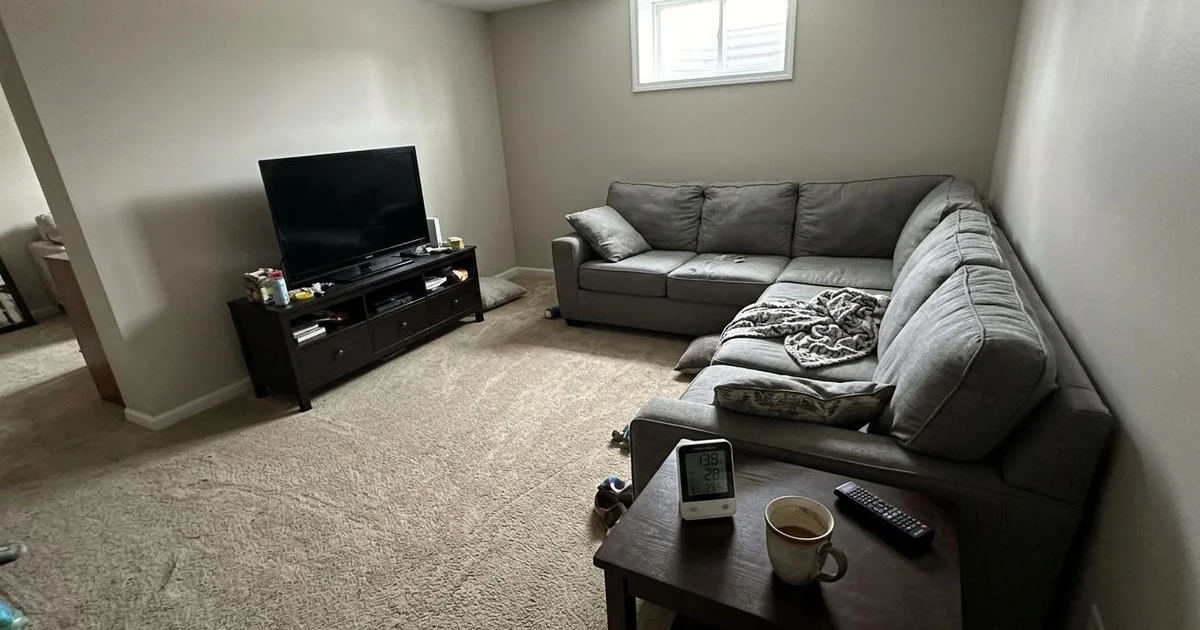 Finished basement family room in an Iowa home with a radon monitor