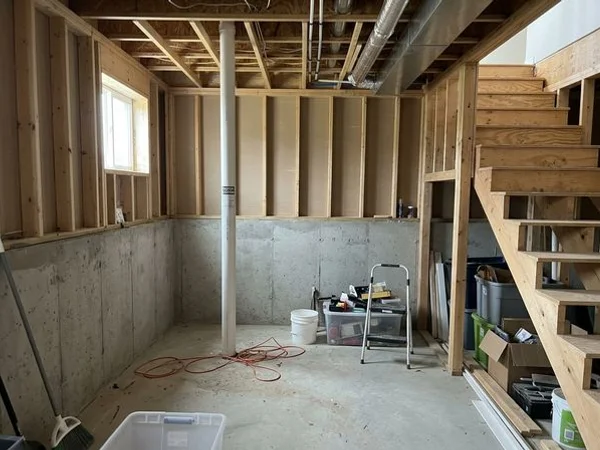 Labeled passive radon vent stack in a new home basement