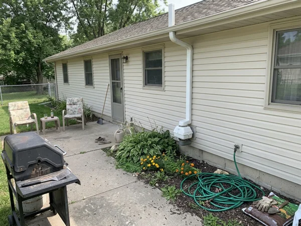 Exterior radon fan and pipe on a ranch home