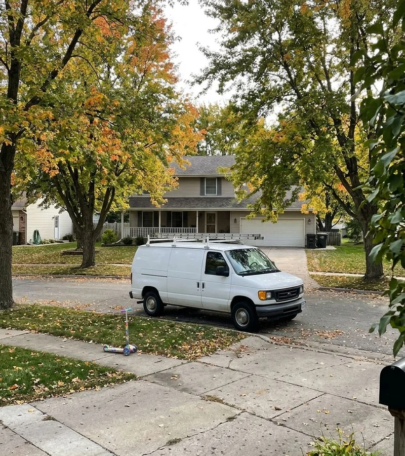 Radon Mitigation Des Moines service van on a residential street